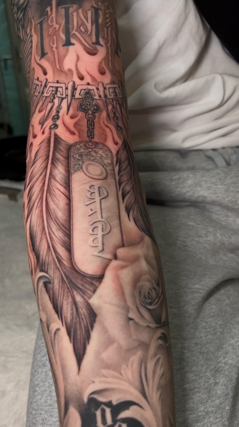 Forearm · Feather & Dog Tag